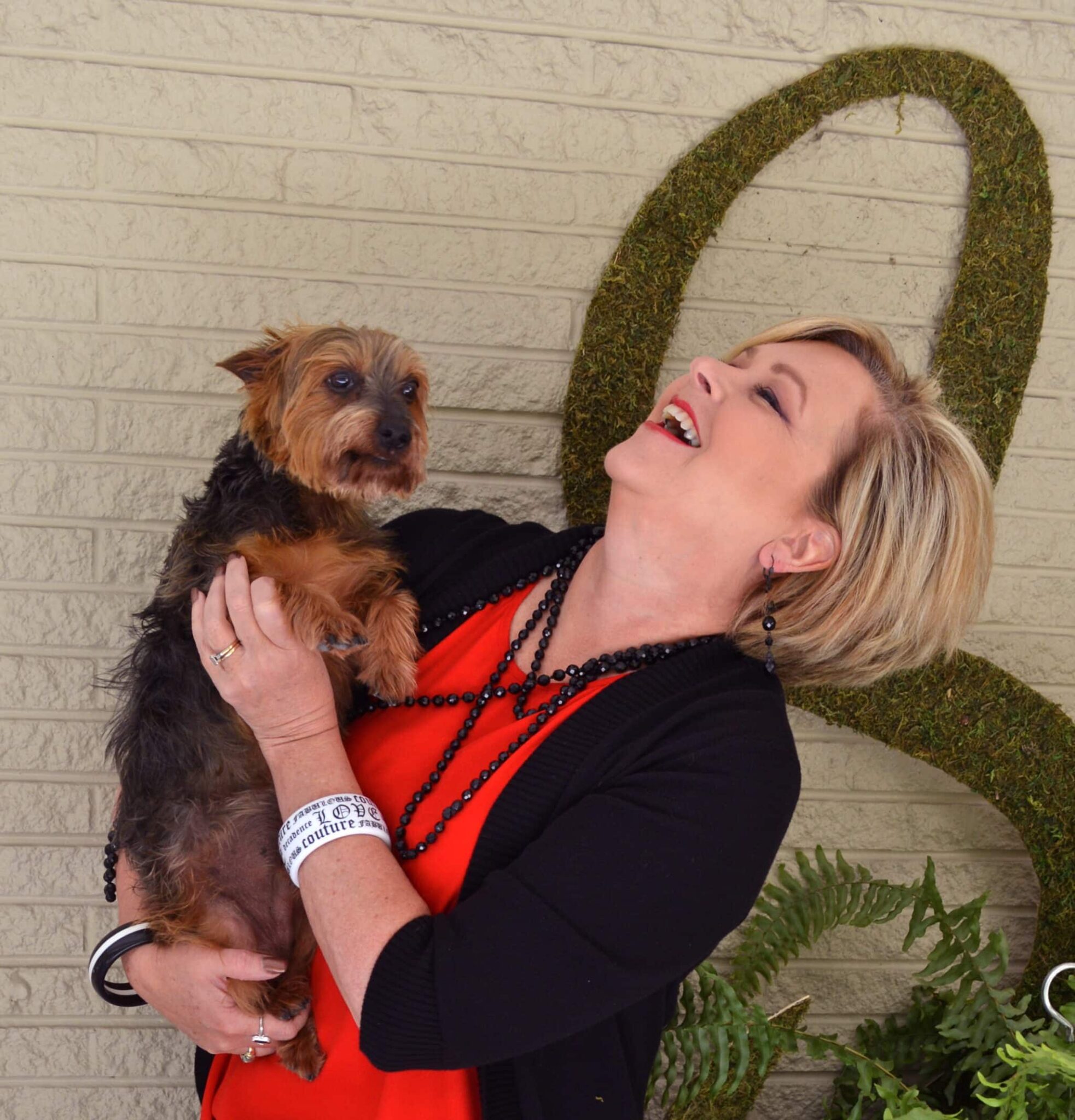 Tania wearing a red shirt with a black cardigan with Beckley