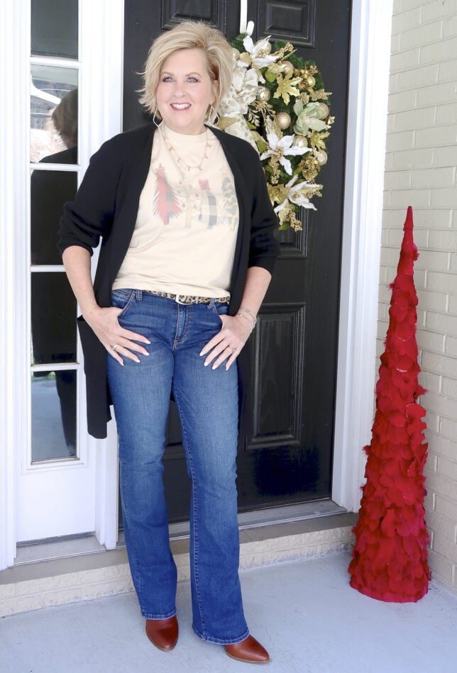 Fashion Blogger 50 Is Not Old looks long and lean in a black cardigan and Kut From The Kloth Flare Jeans