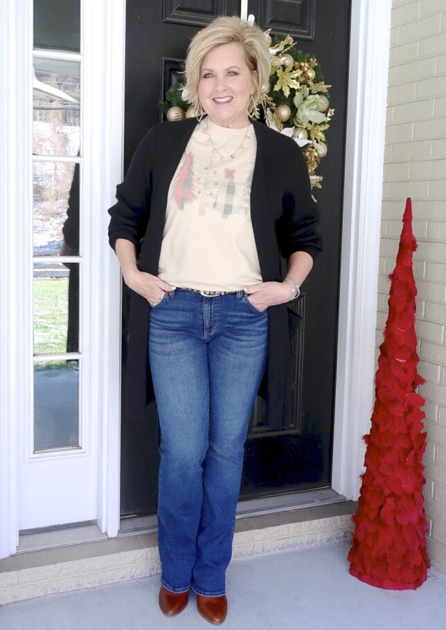 Fashion Blogger 50 Is Not Old wearing a Christmas t-shirt and flare jeans 