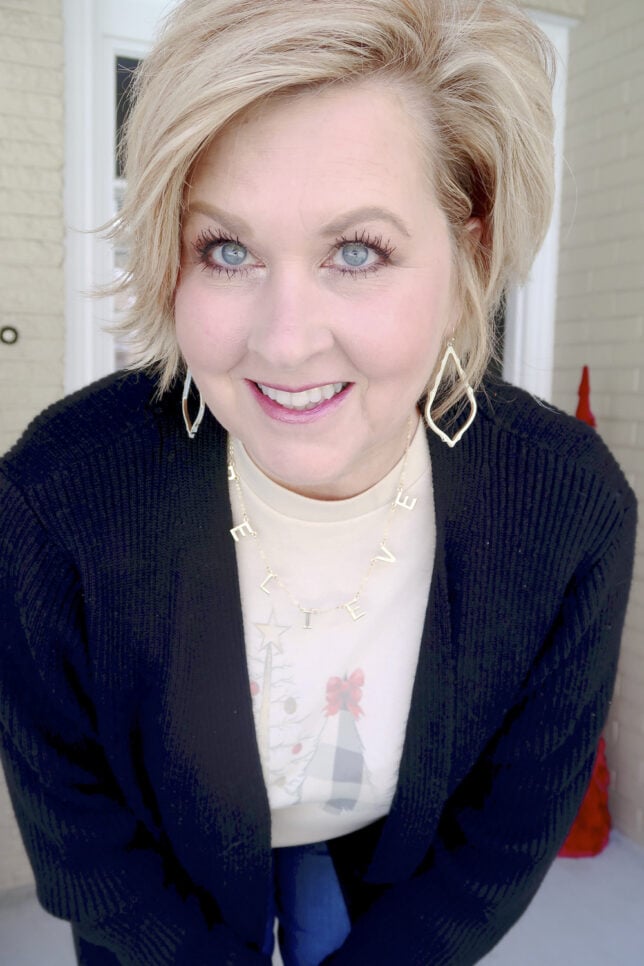 Fashion Blogger 50 Is Not Old with a believe necklace and Kendra Scott earrings