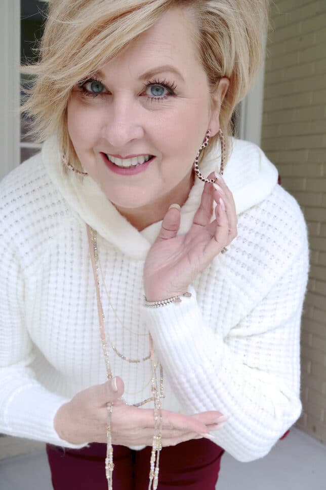A relaxing outfit consisting of a hoodie sweater and heart earrings by Fashion Blogger 50 Is Not Old