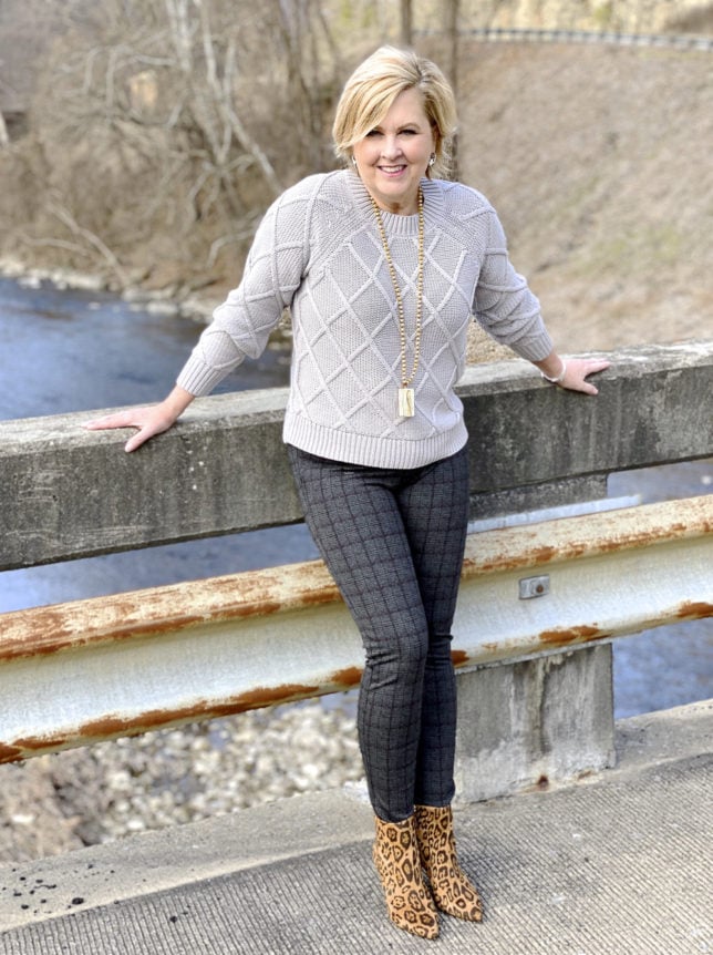 50 Is Not Old blogger wearing a silver sweater and plaid pants.