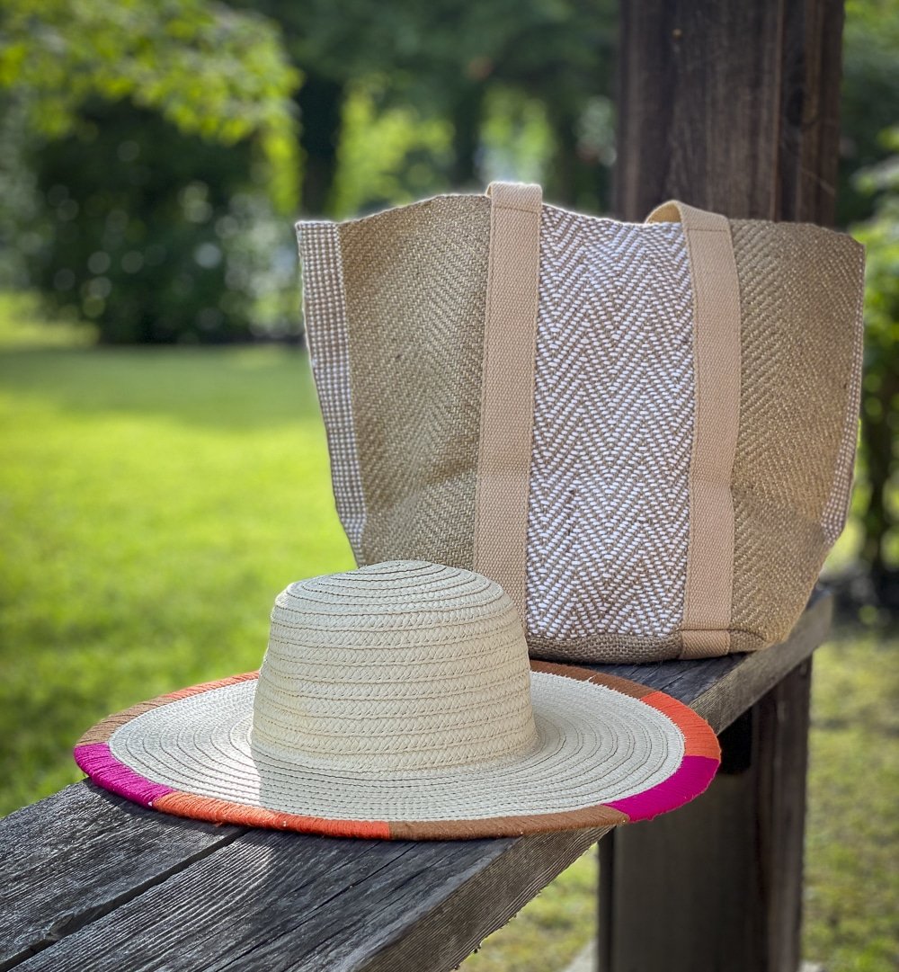 Fashion Blogger 50 Is Not Old is showing a yarn trimmed straw hat, and carrying a jute tote all from Chico's