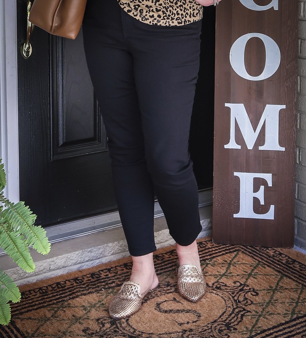 Fashion Blogger 50 Is Not Old is wearing black girlfriend jeans and gold mules