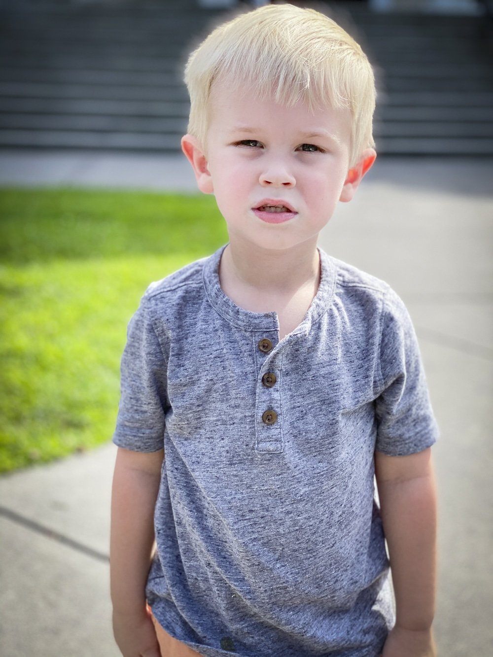Fashion Blogger 50 Is Not Old's grandchildren in their back to school outfits. He is wearing a gray henley tee shirt