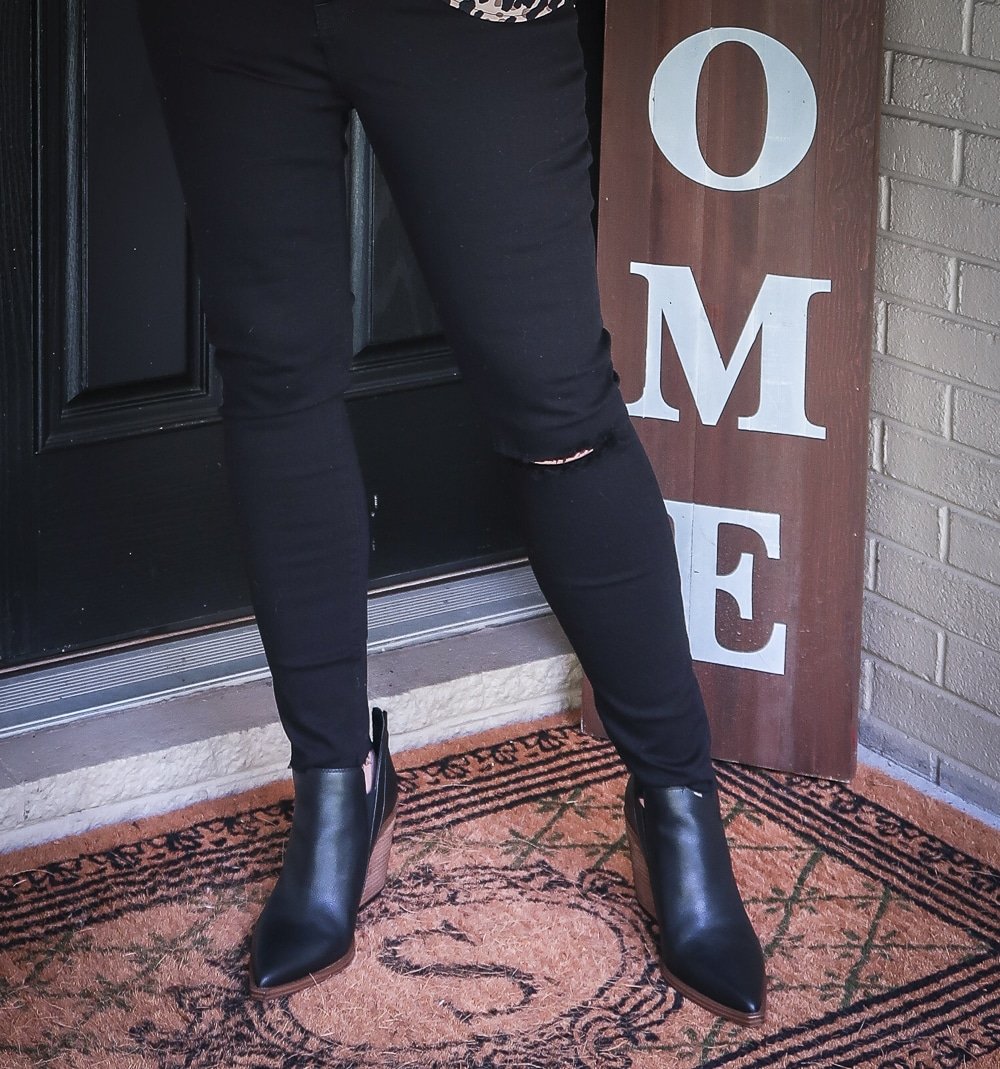 Fashion Blogger 50 Is Not Old is wearing a pair of black distressed jeans by Madewell