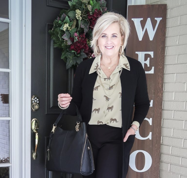 Fashion Blogger 50 Is Not Old is wearing a leopard print button down blouse with a black cardigan