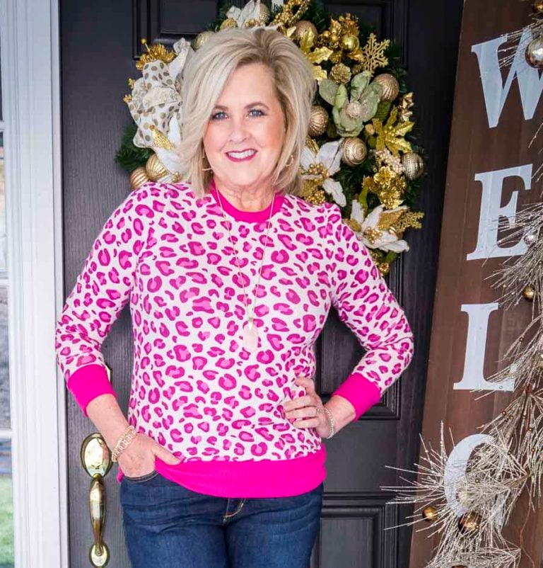 Over 40 Fashion Blogger, 50 Is Not Old, is wearing an eye catching leopard print sweater