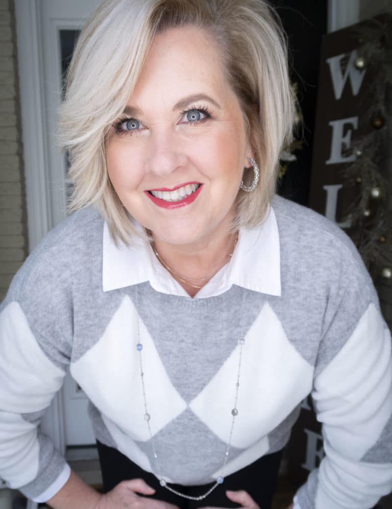 Fashion Blogger 50 Is Not Old is looking polished in this gray and white sweater