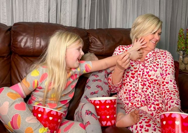 Fashion Blogger 50 Is Not Old is creating memories with her grandchildren as they wipe their cheesy hands on her face