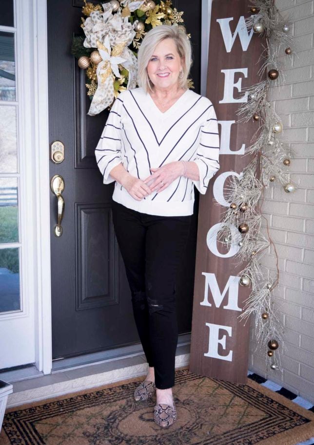 Fashion Blogger 50 Is Not Old is a black and white chevron striped top and distressed black jeans