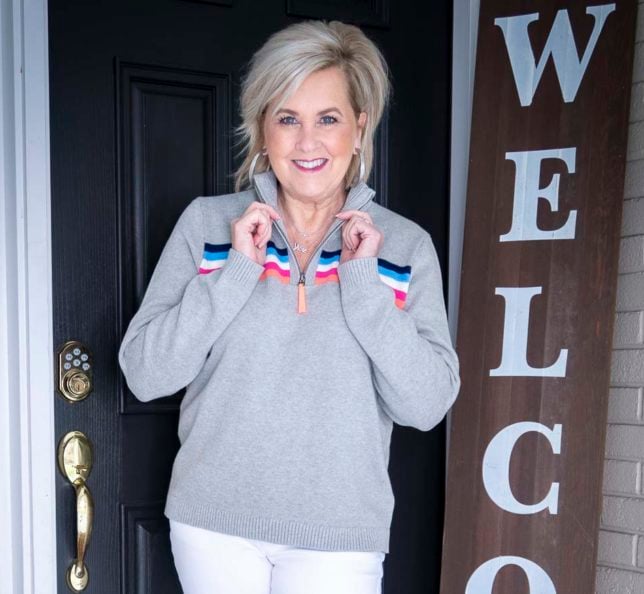Fashion Blogger 50 Is Not Old is wearing a striped gray pullover sweater 