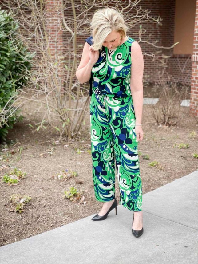 Fashion Blogger 50 Is Not Old is wearing a scroll printed jumpsuit with black heels