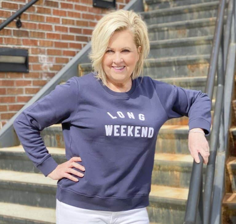 Fashion Blogger 50 Is Not Old is styling a casual weekend outfit of an embroidered navy sweatshirt