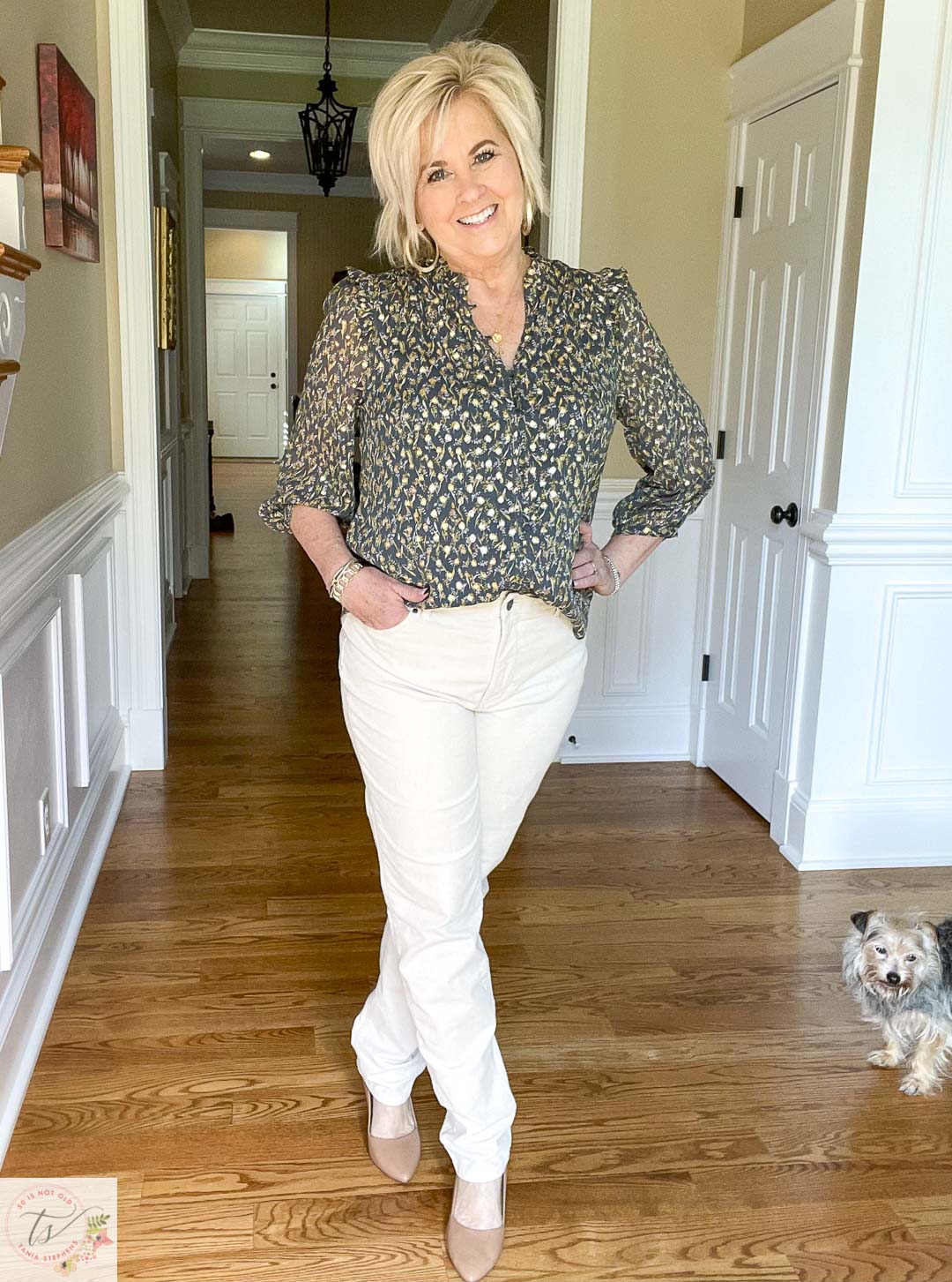 Over 40 fashion blogger, Tania Stephens, is wearing winter white corduroy pants, a dark green top, neutral wedges, and gold jewelry