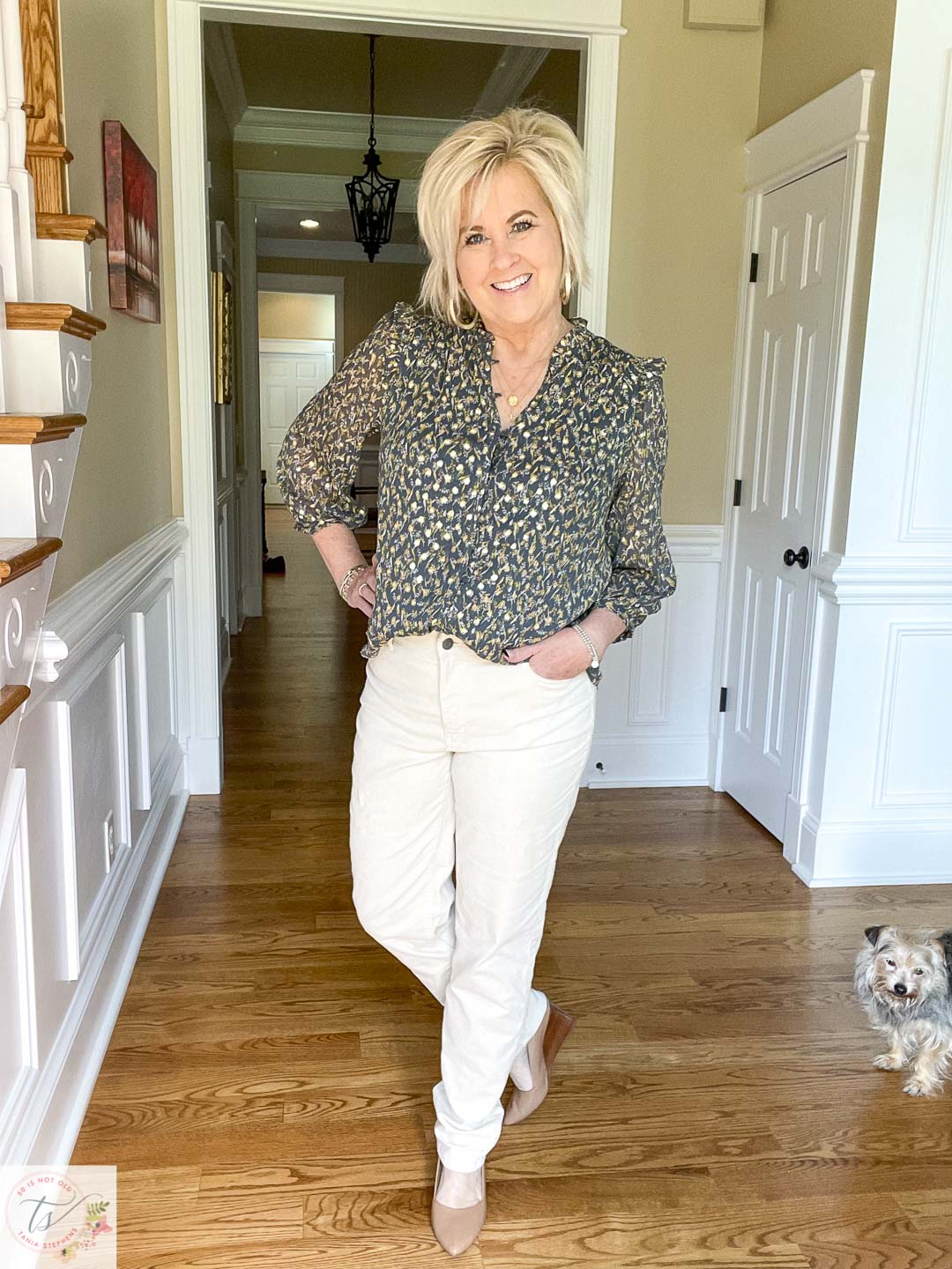 Over 40 fashion blogger, Tania Stephens, is wearing winter white corduroy pants, a dark green top, and neutral shoes