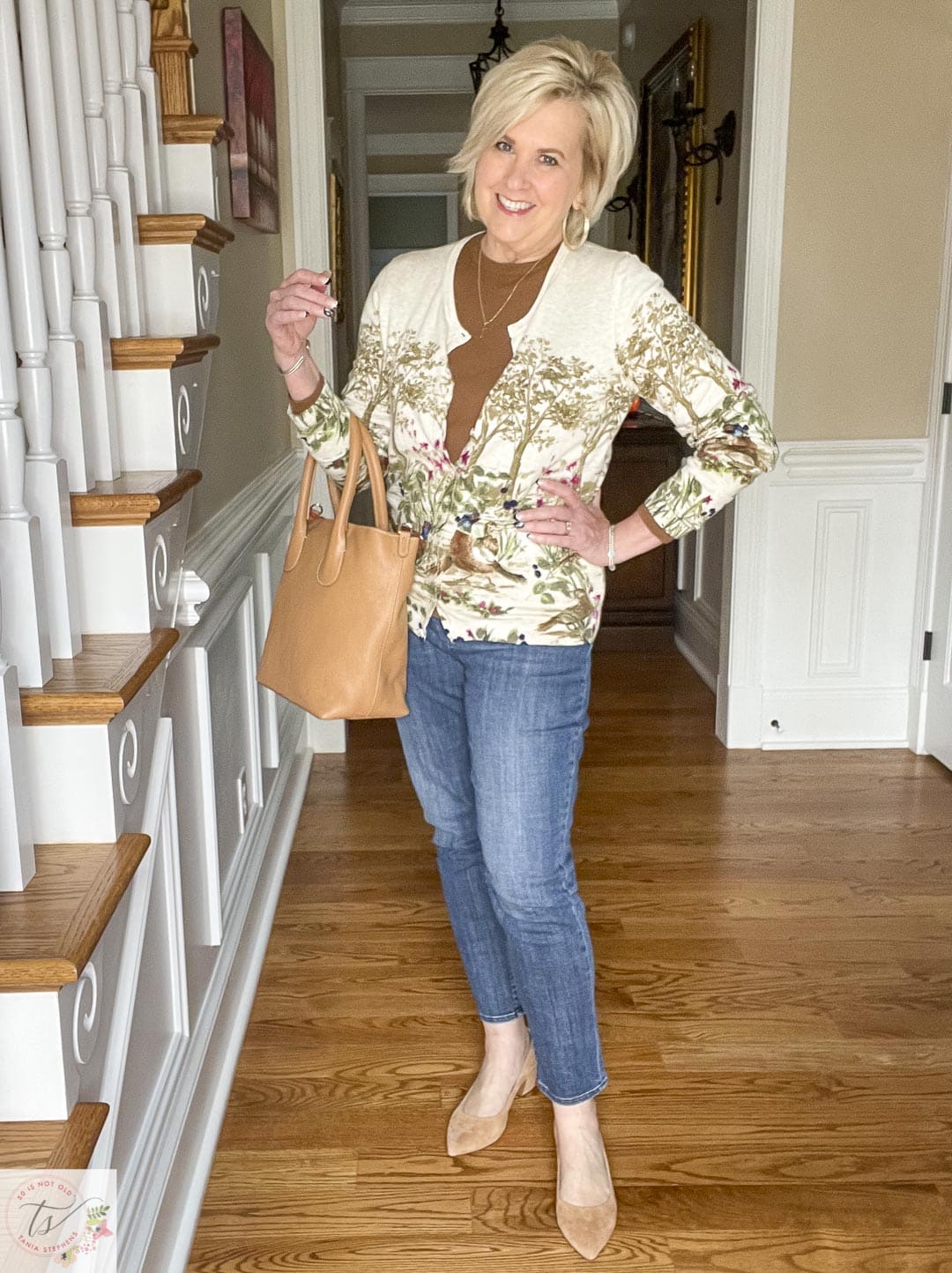 Over 40 Fashion Blogger, Tania Stephens is wearing a pheasant cardigan, girlfriend jeans, Tory Burch ballet flats, block heel suede pumps, and carrying a camel leather tote that is perfect for Thanksgiving