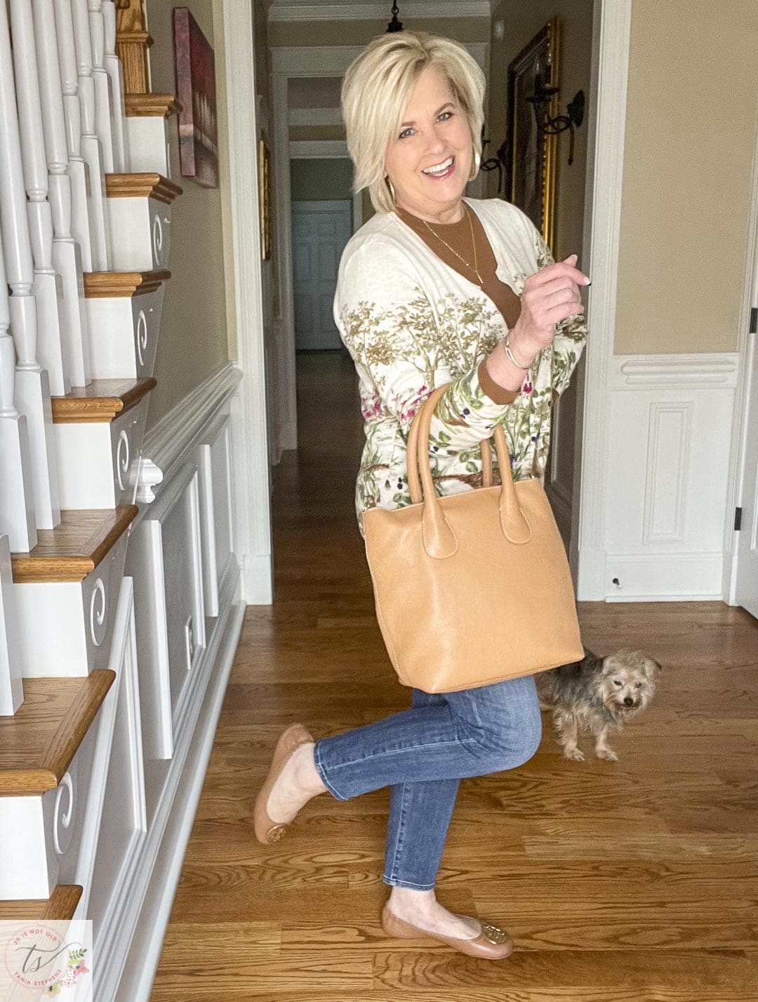Over 40 Fashion Blogger, Tania Stephens is wearing a pheasant cardigan, girlfriend jeans, ballet flats, and carrying a camel leather tote 