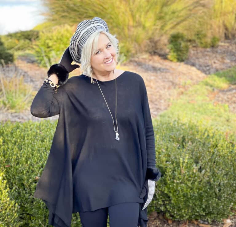 Over 40 Fashion Blogger, Tania Stephens is wearing a black on black outfit with a black and white beret and gloves