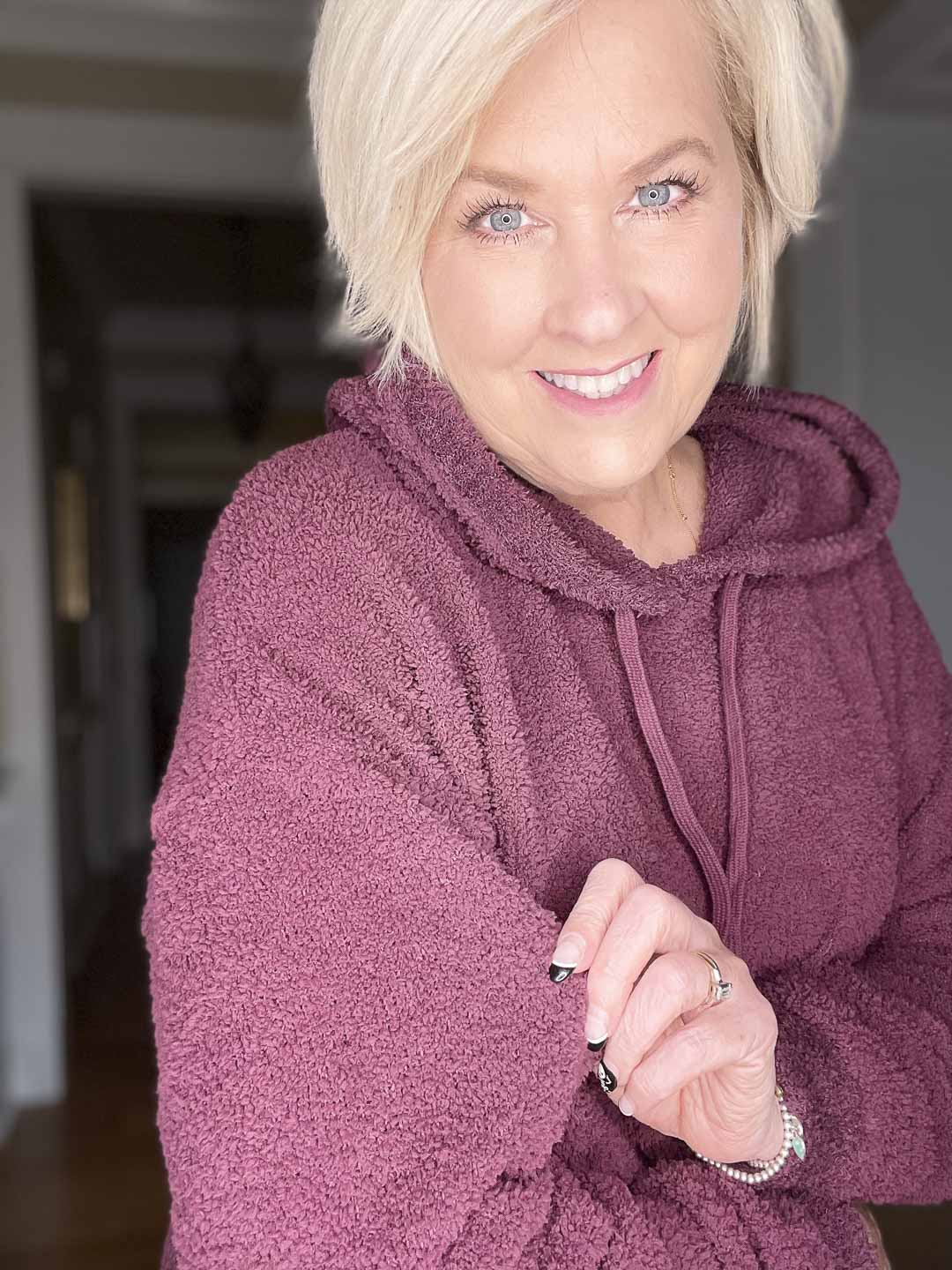 Over 40 Fashion Blogger, Tania Stephens is wearing a burgundy cozy sweatshirt