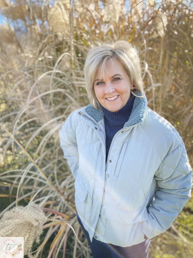 Over 40 Fashion Blogger, Tania Stephens is wearing an aqua puffer jacket with sneakers