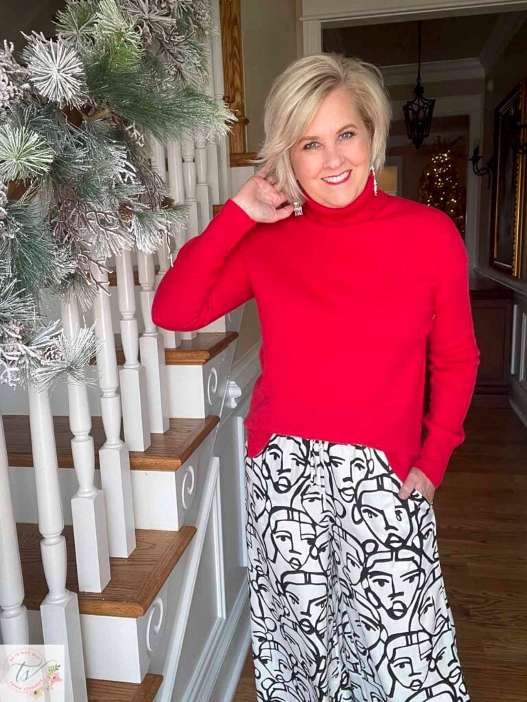 Over 40 Fashion Blogger, Tania Stephens is wearing a red cashmere turtleneck and a pair of printed lounge pants