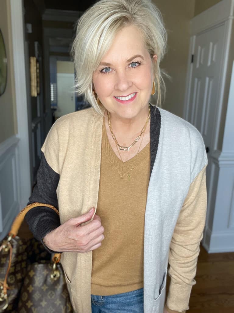Over 40 Fashion Blogger, Tania Stephens is wearing a brown v-neck sweater with a colorblock cardigan