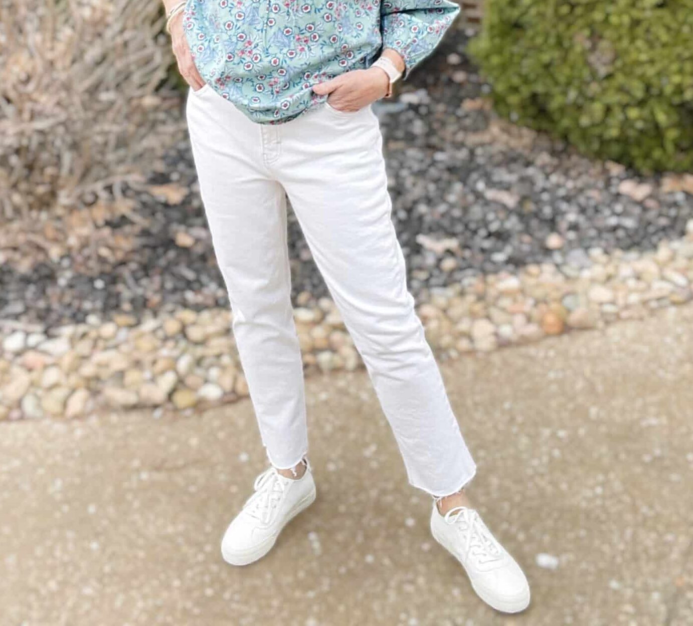 Over 40 Fashion Blogger, Tania Stephens is wearing a pale blue floral top and white raw hem jeans 2