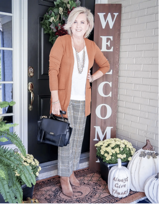 Tania wearing plaid pants and a brown cardigan