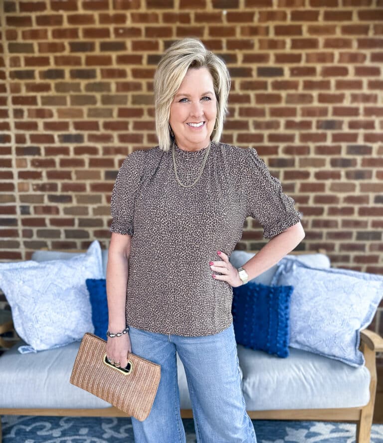 Tania Stephens is wearing a casual leopard print outfit with wide leg jeans and a black blazer16