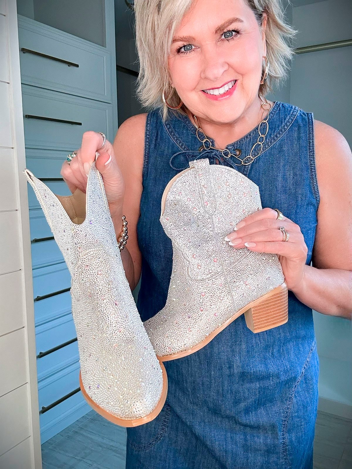 Over 50 Fashion Blogger, Tania Stephens is wearing a denim dress with a pair of brown boots5