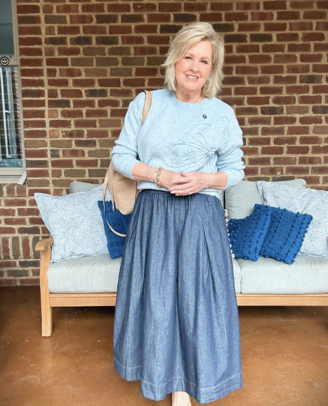 Tania Stephens showing a floral sweater shirt with a denim skirt from Walmart