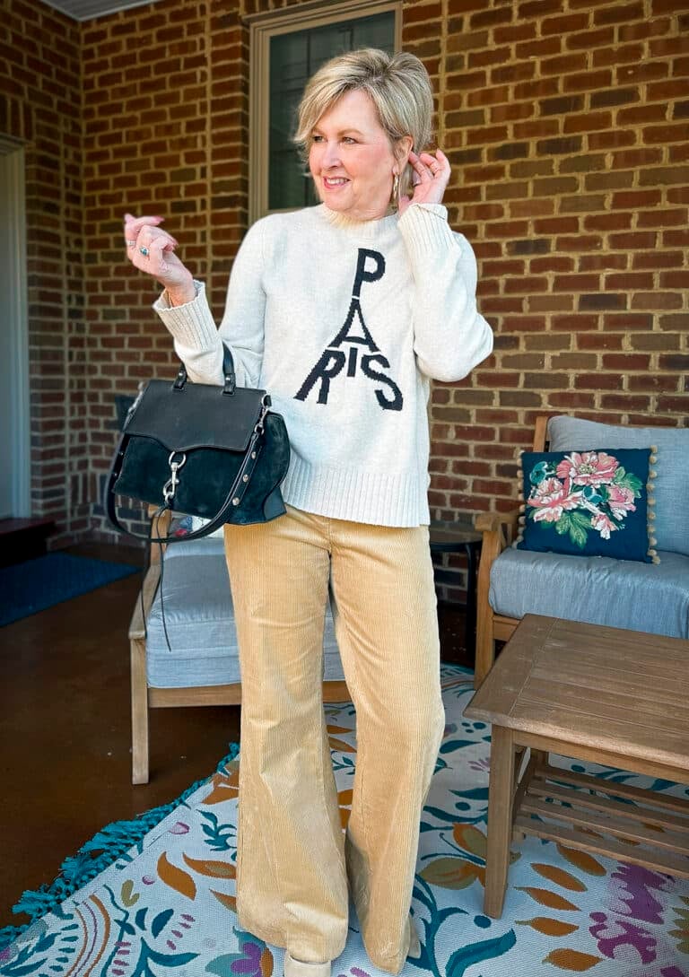 Tania Stephens is wearing a Paris sweater and corduroy pants