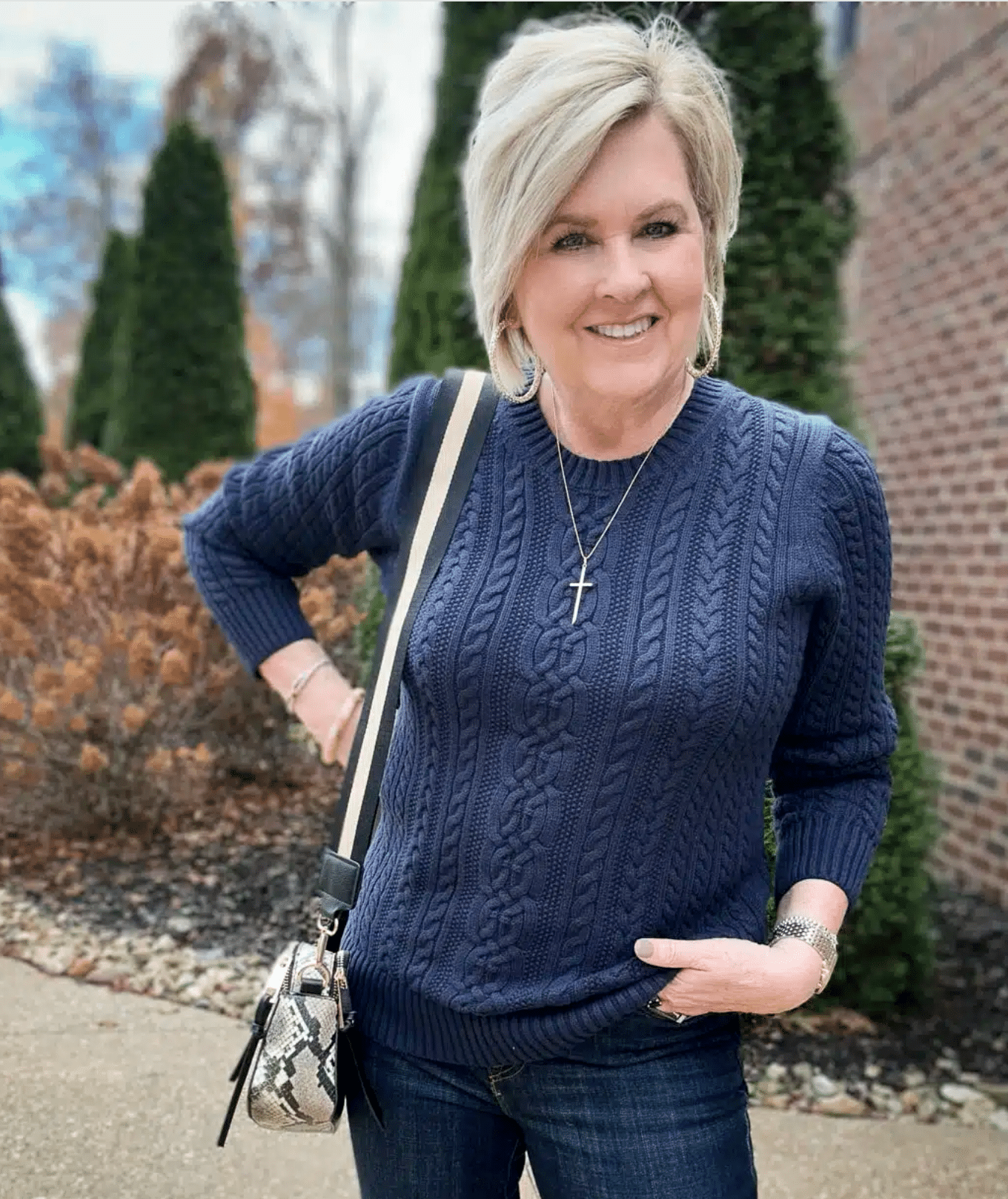 Tania Stephens is wearing a navy blue chunky knit sweater