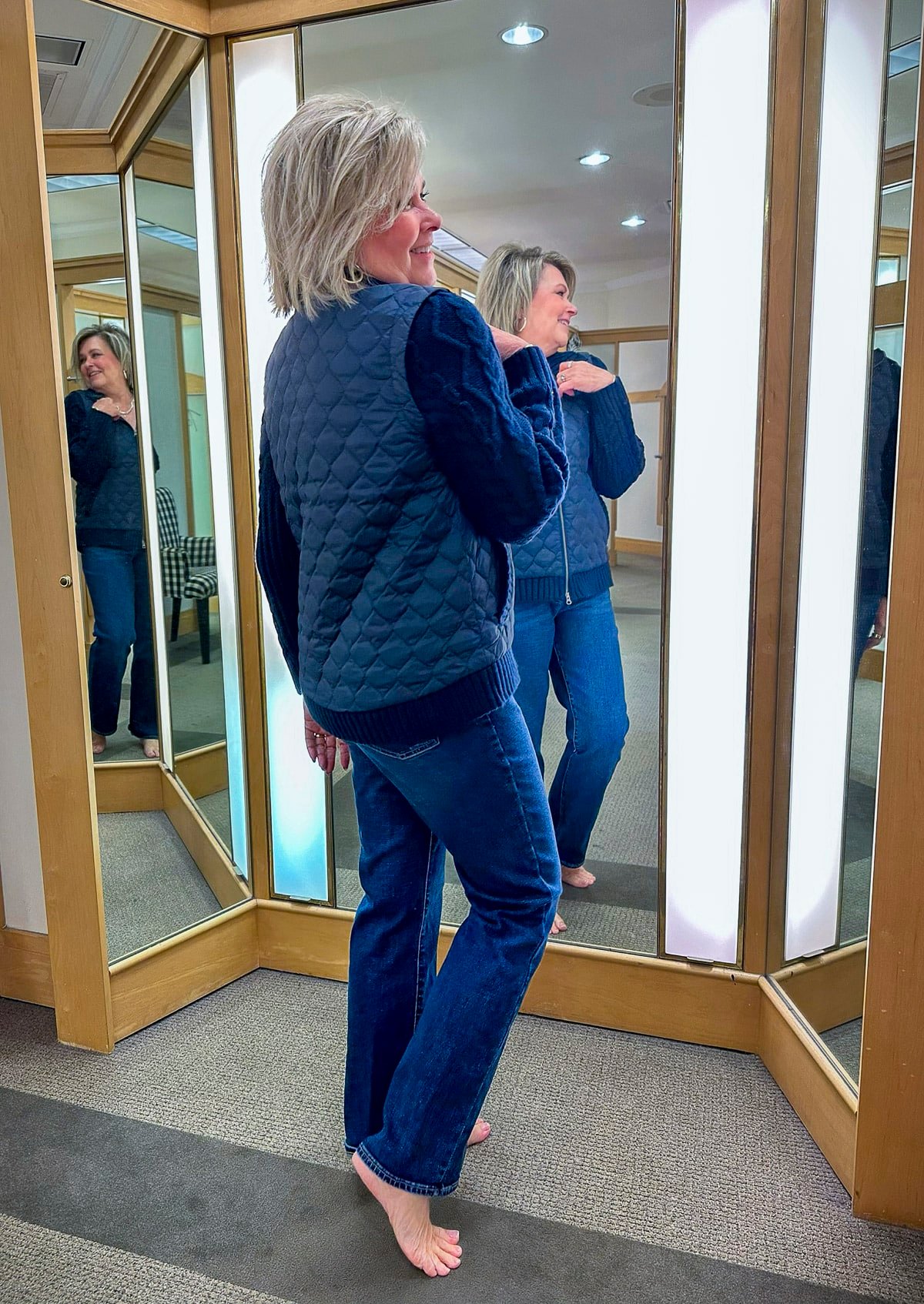 Tania Stephens is trying on a navy Talbots jacket and bootcut jeans