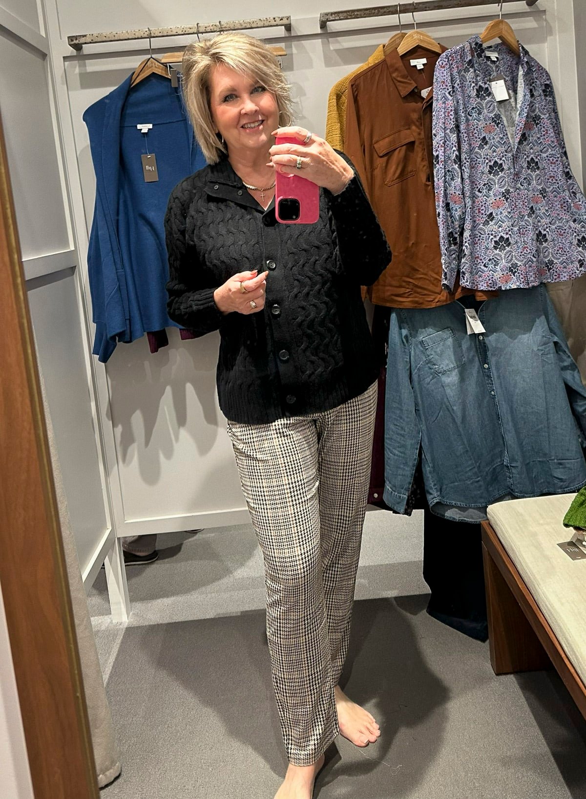 Tania Stephens is wearing a black cardigan and plaid pants