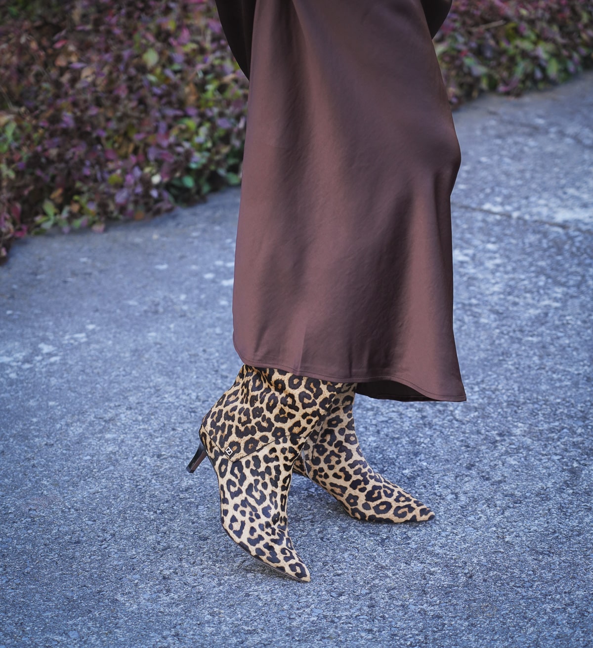 Tania Stephens is wearing a brown satin slip with leopard print boots