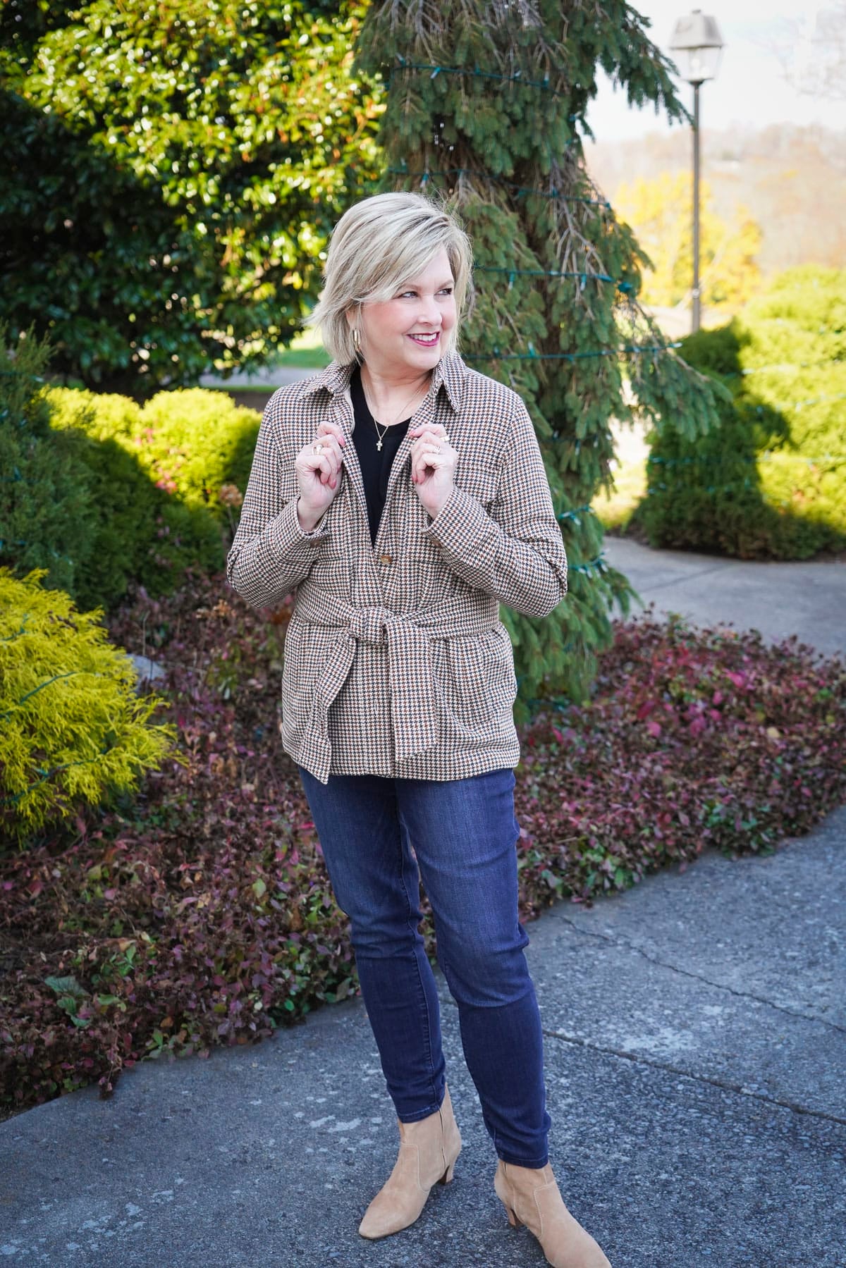 Tania Stephens is wearing a black tee, and a  belted plaid jacket for winter from Nordstrom