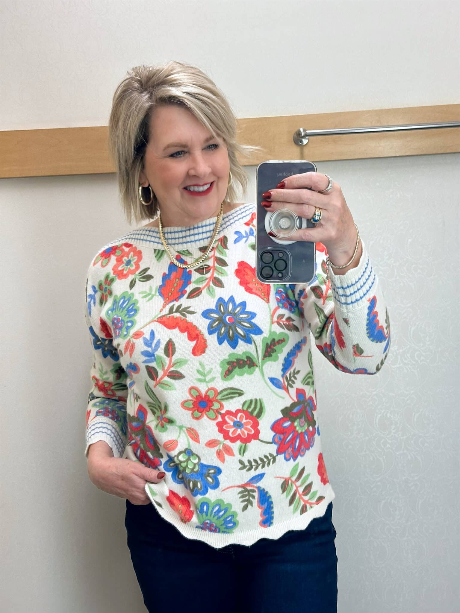 Tania Stephens is wearing a floral sweater