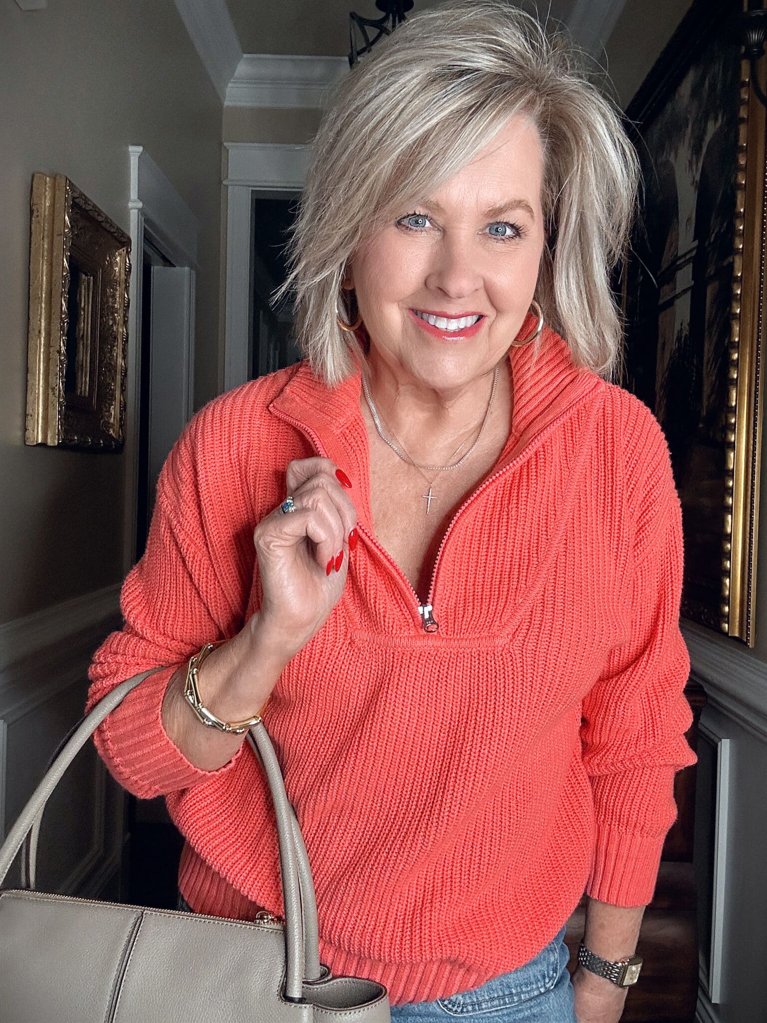 Over 50 Fashion Blogger, Tania Stephens, wearing a bright coral half zip sweater from Walmart