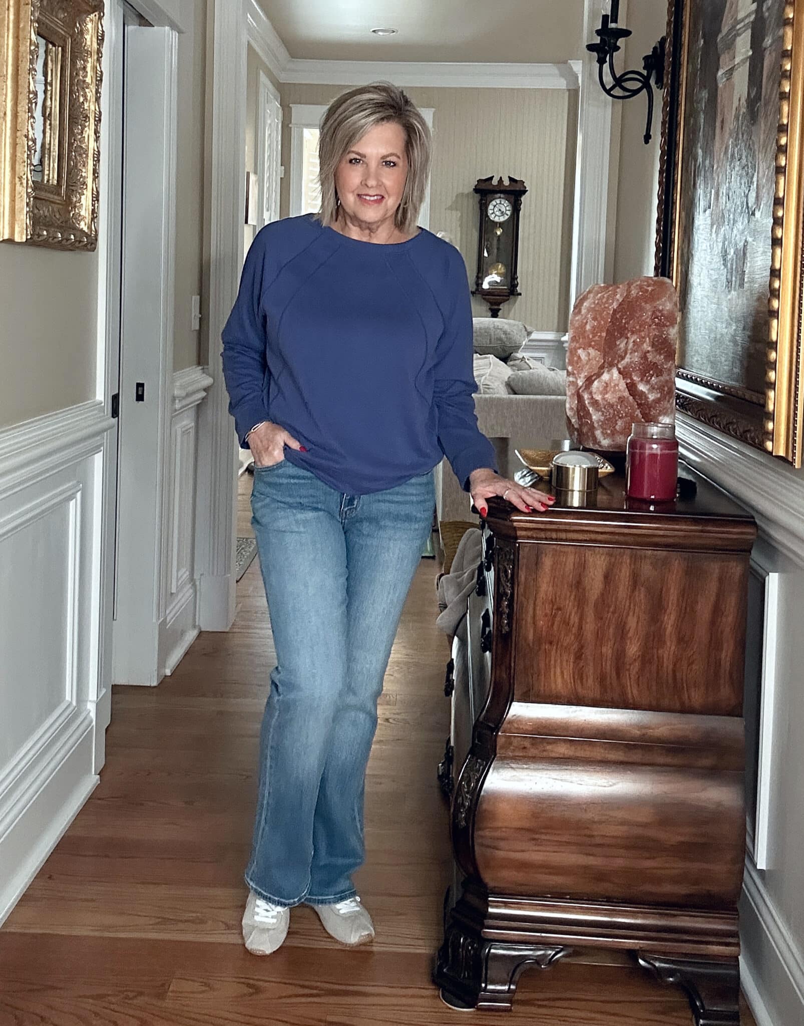 Over 50 Fashion Blogger, Tania Stephens, wearing a purple/blue sweatshirt and jeans