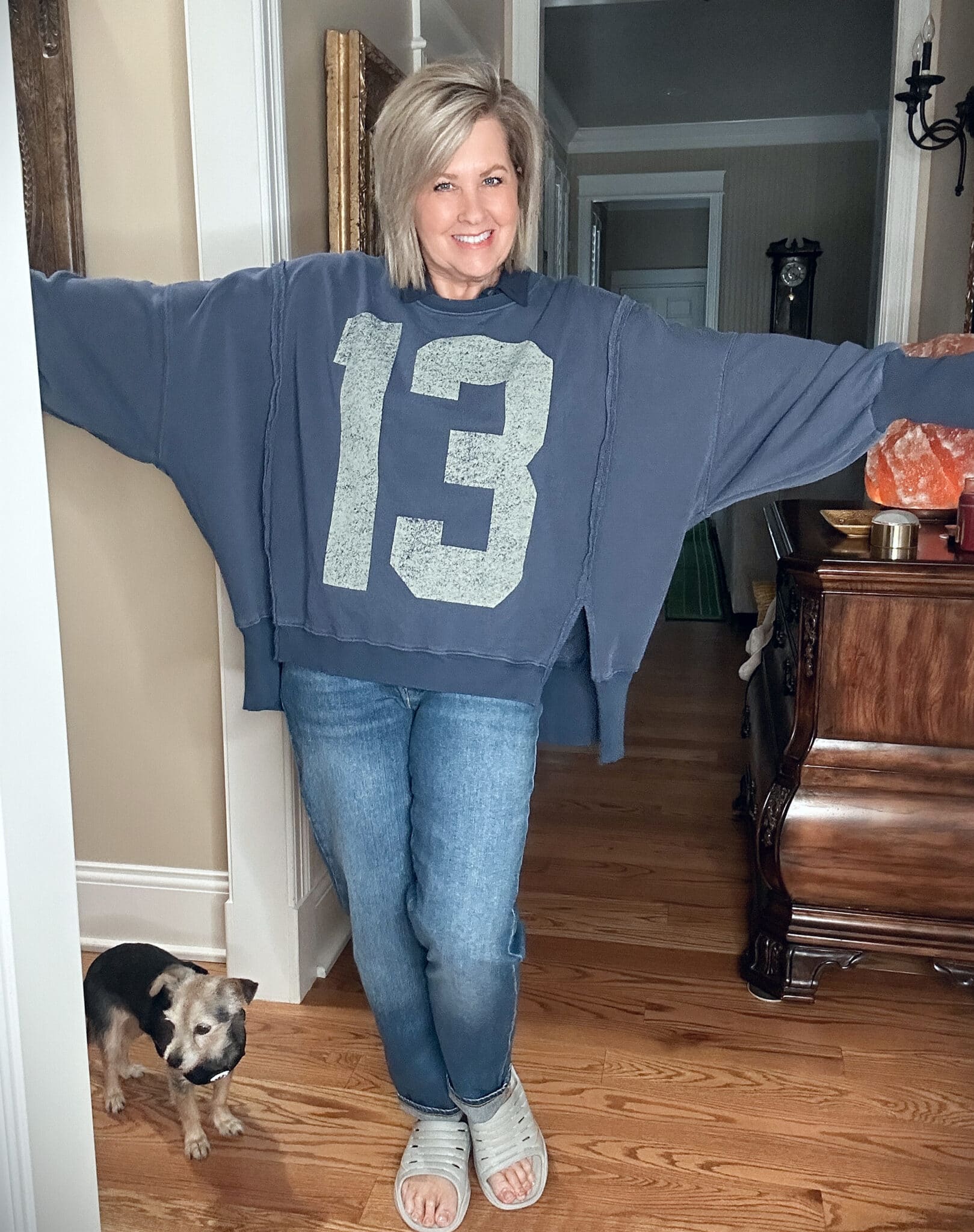 Over 50 Fashion Blogger, Tania Stephens, wearing a blue #13 sweatshirt and jeans