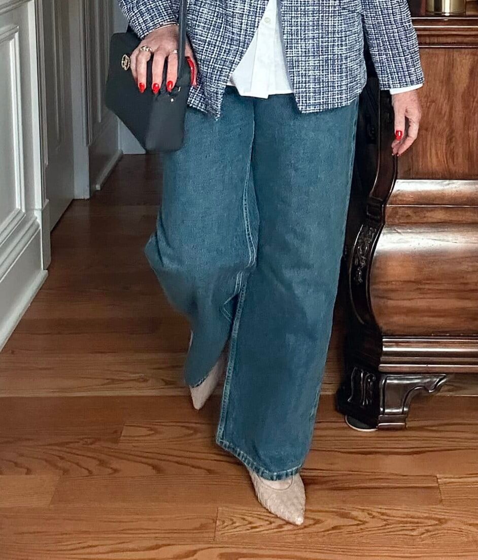 Over 50 fashion blogger, Tania Stephens is wearing a pair of wide leg jeans