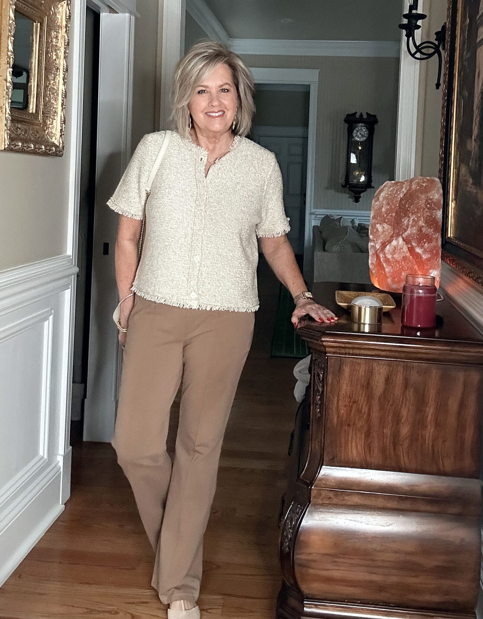 Over 50 Fashion Blogger, Tania Stephens is wearing a neutral outfit consisting of a beige fringed top with tan pants