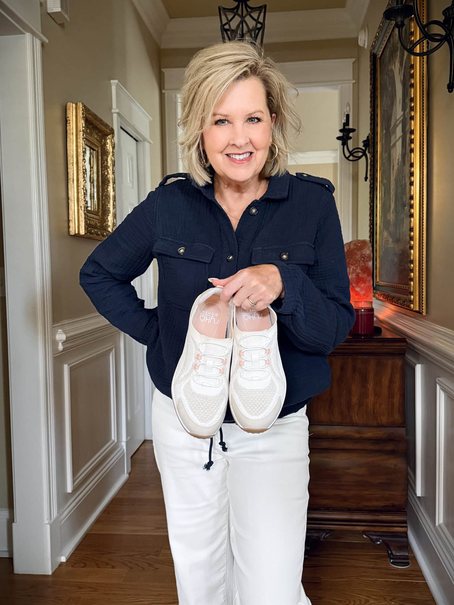Tania Stephens is wearing a blue gauze jacket, white jeans, and sneakers from Walmart