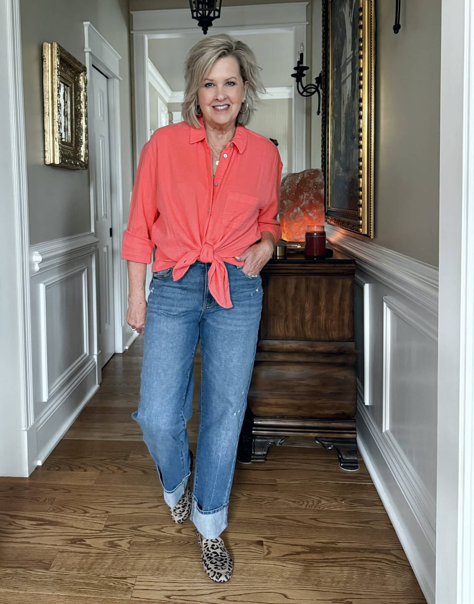 Tania Stephens is wearing a coral gauze shirt and cuffed jeans from Walmart