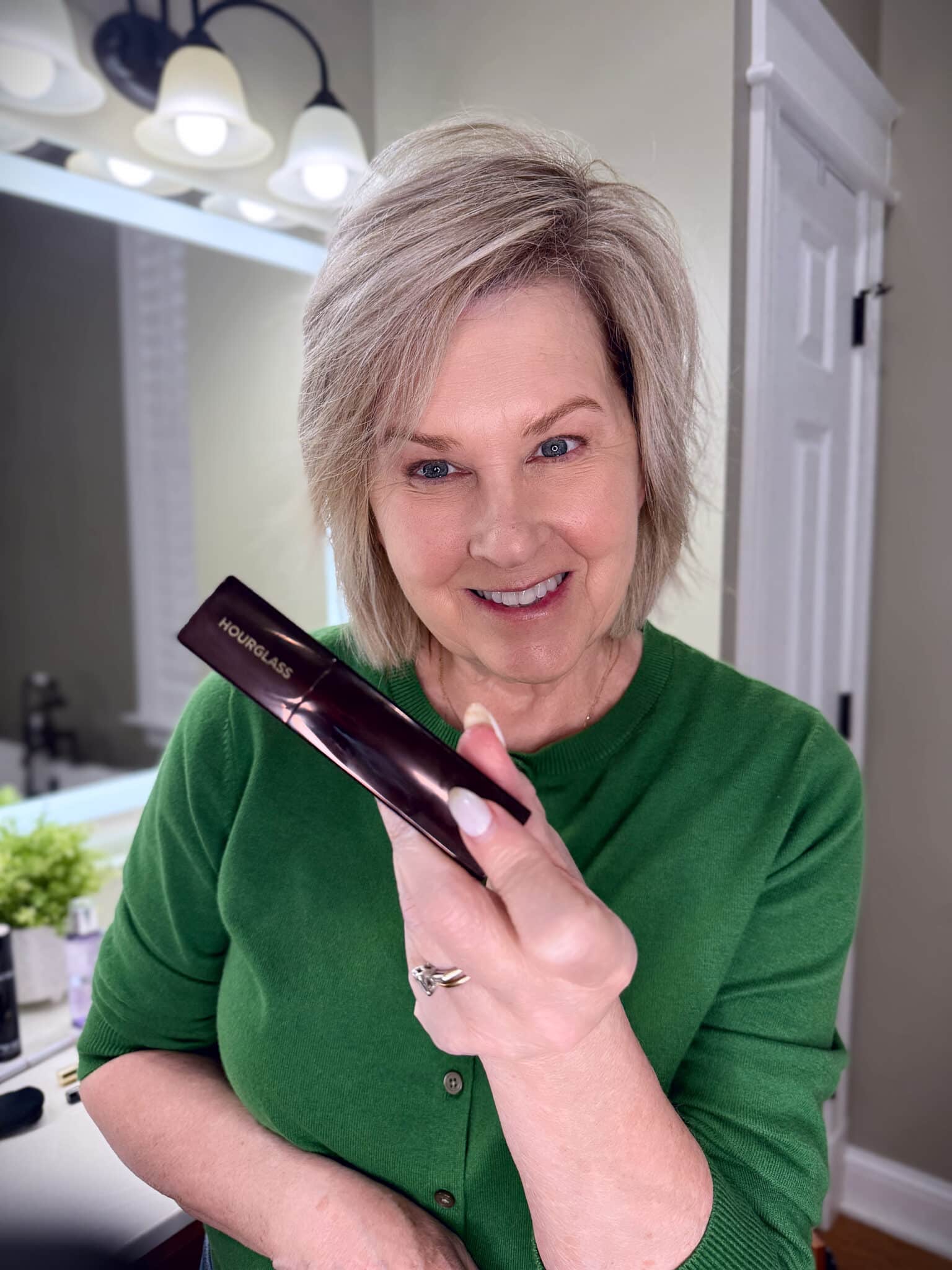 Tania Stephens in a green sweater with Hourglass concealer makeup from Nordstrom Beauty