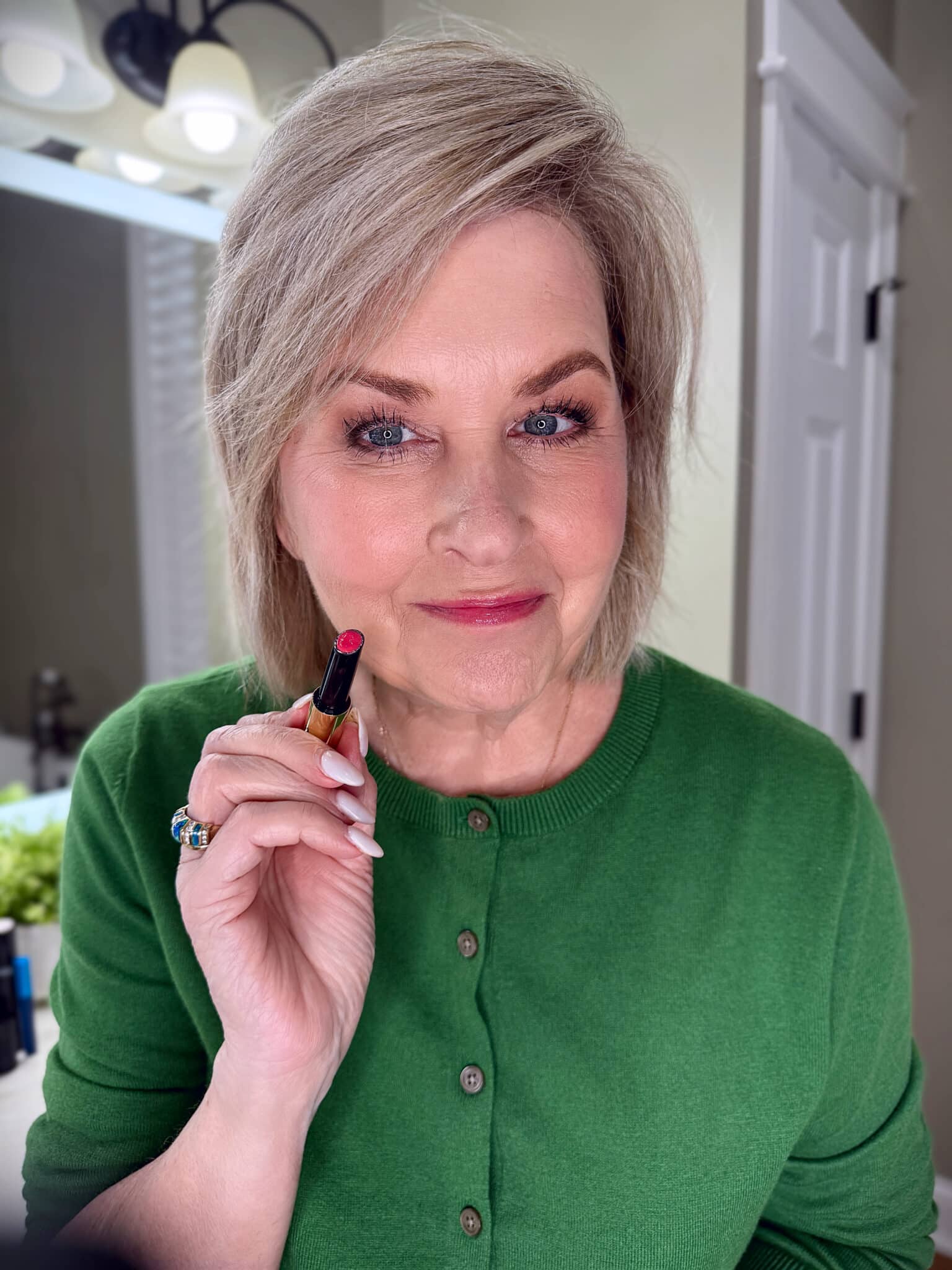 Tania Stephens in a green sweater with Hourglass lip makeup from Nordstrom Beauty
