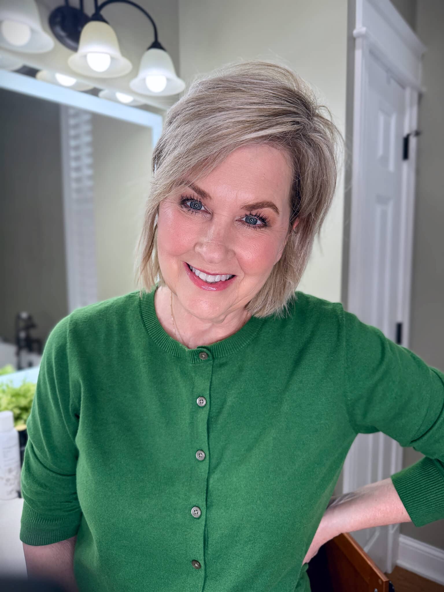 Tania Stephens in a green sweater with makeup from Nordstrom Beauty