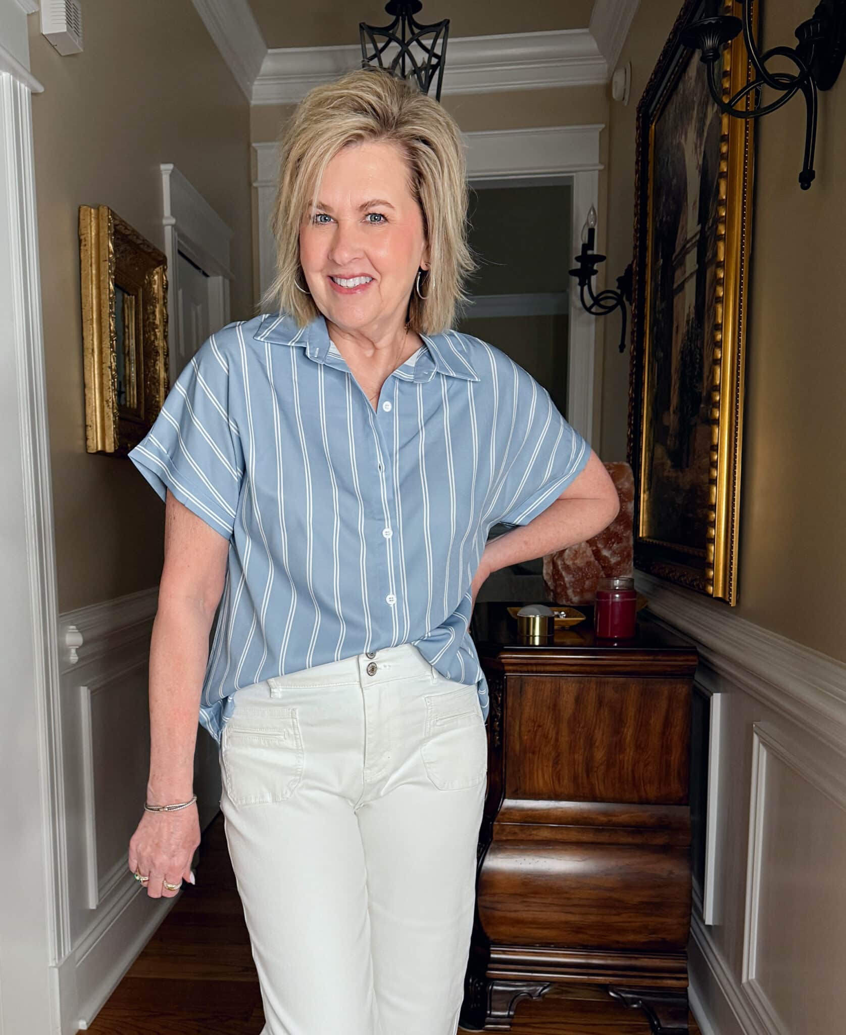 Tania Stephens is wearing a pair of white jeans and a tucked blue and white striped top from Amazon